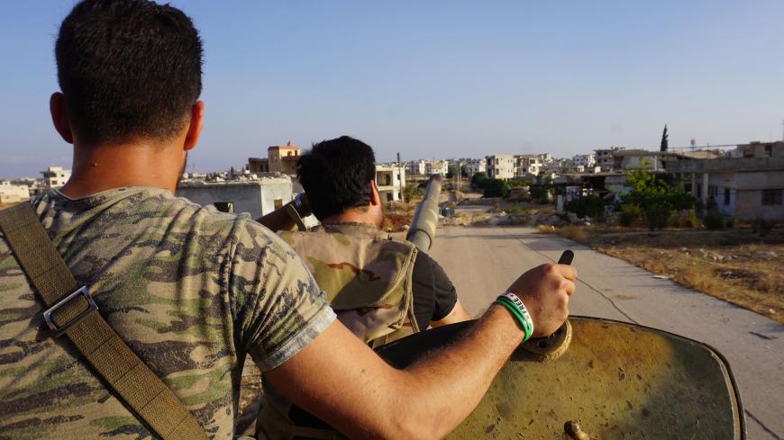 A picture taken on July 19, 2018 shows rebel fighters on a tank, entering town of Fuaa in the northwestern Syrian province of Idlib after thousands of its residents were evacuated to regime-controlled areas. - Several thousand residents evacuated two pro-regime towns in northern Syria today, putting an end to one of the longest sieges of the country's seven-year civil war.
Fuaa and Kafraya in Idlib province were the last remaining areas under blockade in Syria and a rare example of pro-government towns surr