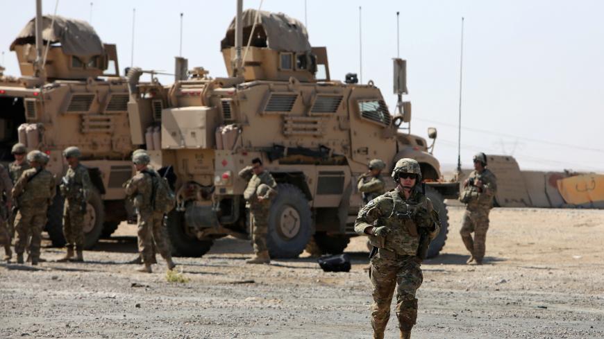 A U.S. soldier runs at a coalition forces forward base near West Mosul, Iraq June 21, 2017, where Iraqi security forces are fighting Islamic State.     REUTERS/Marius Bosch - RC1F464C5CA0