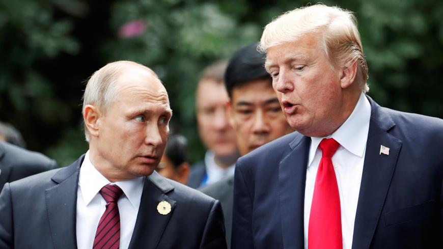 U.S. President Donald Trump and Russia's President Vladimir Putin talk during the family photo session at the APEC Summit in Danang, Vietnam November 11, 2017. REUTERS/Jorge Silva     TPX IMAGES OF THE DAY - RC1E7D8D2110