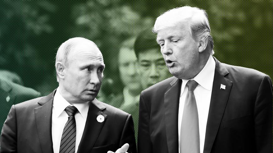 U.S. President Donald Trump and Russia's President Vladimir Putin talk during the family photo session at the APEC Summit in Danang, Vietnam November 11, 2017. REUTERS/Jorge Silva - RC1B1EDB0E40