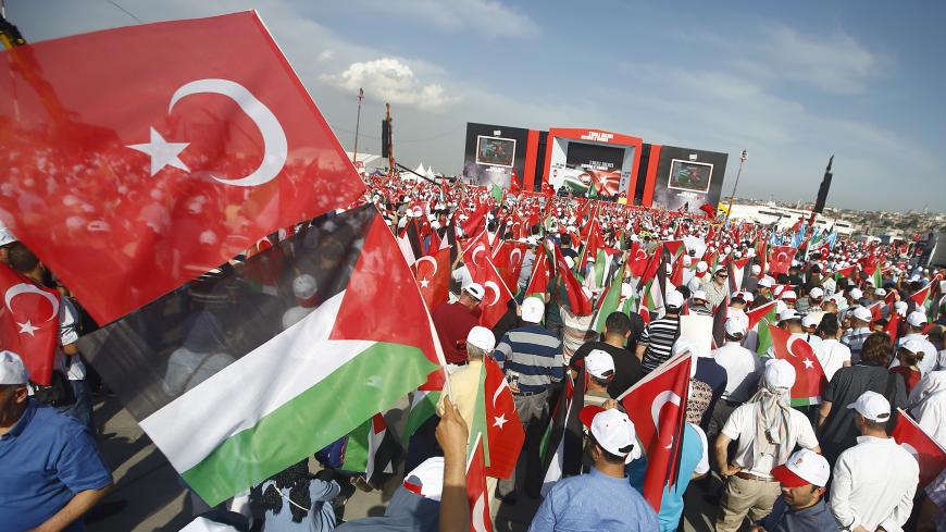 Demonstrators wave flags during a protest against the recent killings of Palestinian protesters on the Gaza-Israel border and the U.S. embassy move to Jerusalem, in Istanbul, Turkey May 18, 2018. REUTERS/Osman Orsal - UP1EE5I1A5E18