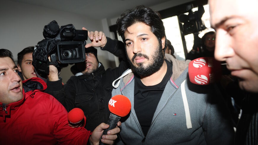 Detained Azerbaijani businessman Reza Zarrab (C) is surrounded by journalists as he arrives at a police center in Istanbul on December 17 ,2013. Turkish police detained more than 20 people including the sons of three cabinet ministers and several high-profile businessmen on December 17 in a probe into alleged bribery and corruption, local media reported. Prime Minister Recep Tayyip Erdogan's ruling Justice and Development Party (AKP), which boasts of being pro-business, has pledged to root out corruption, a