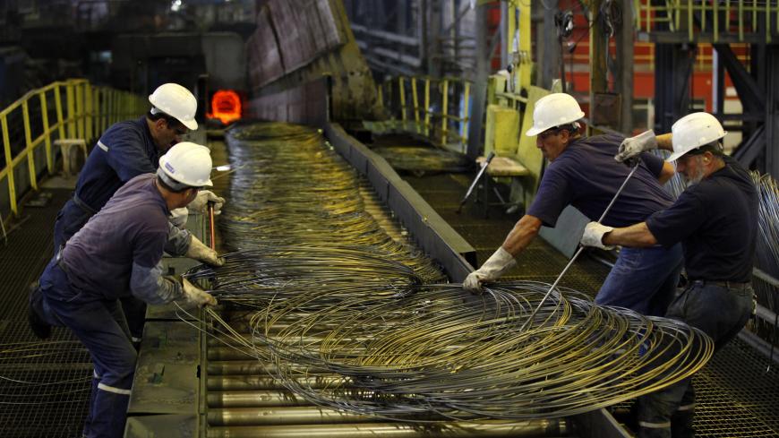 Workers handle steel cables at Turkish steel manufacturer ISDEMIR in Iskenderun in Hatay province May 6, 2010. REUTERS/Umit Bektas (TURKEY - Tags: EMPLOYMENT BUSINESS) - GM1E6561J5Y01