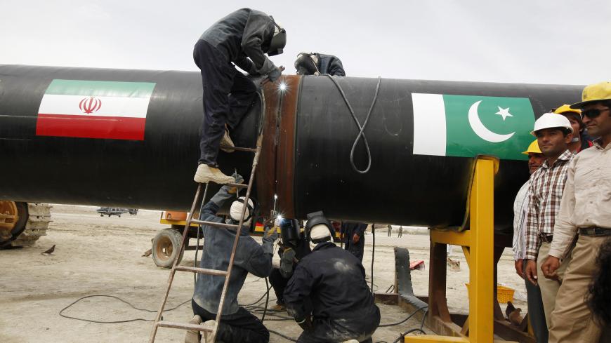 Irani workers weld the pipeline during a groundbreaking ceremony to mark the inauguration of the Iran-Pakistan gas pipeline, in the city of Chahbahar in southeastern Iran March 11, 2013. Ahmadinejad and Zardari marked the start of Pakistani construction on the much-delayed gas pipeline on Monday, Iranian media reported, despite U.S. pressure on Islamabad to back out of the project. REUTERS/Mian Khursheed  (IRAN - Tags: POLITICS ENERGY BUSINESS) - GM1E93C06X401