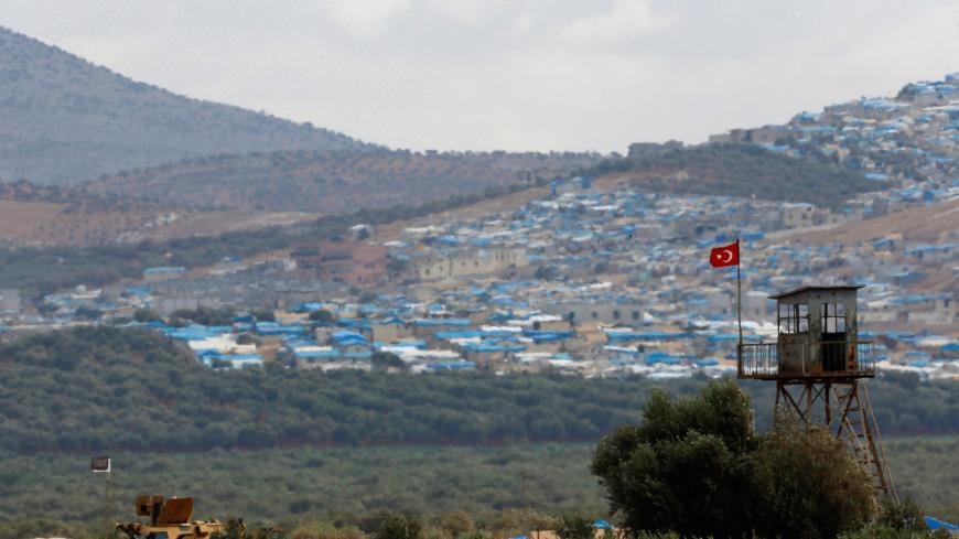 A Turkish military armoured vehicle guards on the border line located opposite the Syrian town of Atimah, Idlib province, in this picture taken from Reyhanli, Hatay province, Turkey October 10, 2017. REUTERS/Osman Orsal - RC117E0C0980