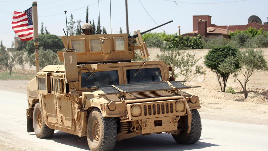 The U.S. flag flutters on a military vehicle in Manbej countryside, Syria May 12, 2018. REUTERS/Aboud Hamam - RC11141AD840