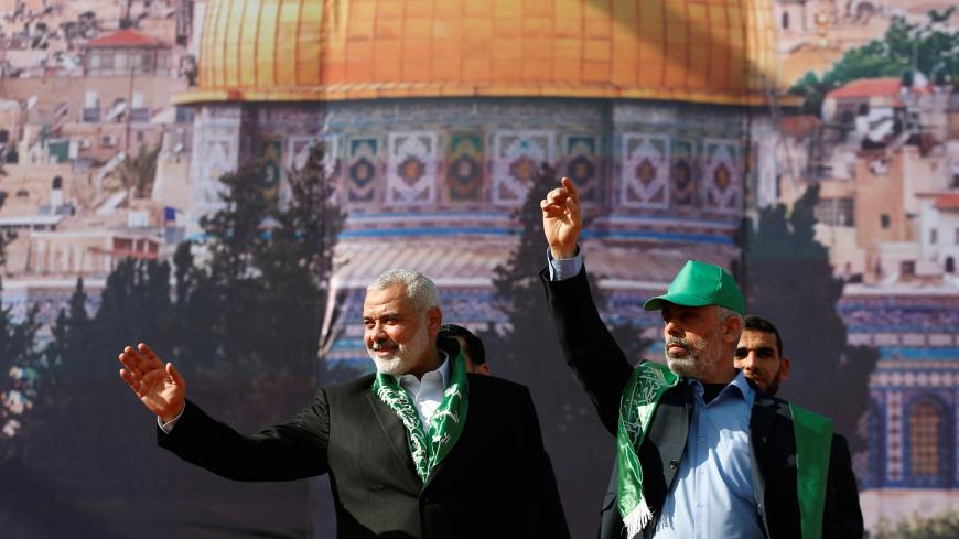 Hamas Chief Ismail Haniyeh and Gaza's Hamas Chief Yehya Al-Sinwar gesture to supporters during a rally marking the 30th anniversary of Hamas' founding, in Gaza City December 14, 2017. REUTERS/Mohammed Salem - RC1F66142030