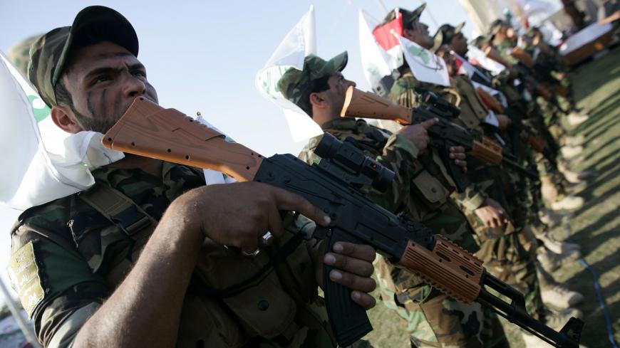 Members of Iraq's Shi'ite militia Asaib Ahl al-Haq, who are supporters of Syrian President Bashar al-Assad, take part in a parade in Karbala March 21, 2014.REUTERS/Mushtaq Muhammed (IRAQ - Tags: CIVIL UNREST MILITARY POLITICS CONFLICT) - GM1EA3M0DPL01