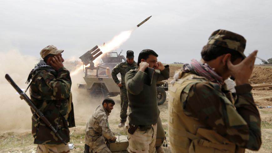 Shi'ite fighters cover their ears as a rocket is launched during a clash with Islamic State militants in the town of al-Alam March 9, 2015. Just north of Tikrit, home city of executed Sunni former president Saddam Hussein, Iraqi security forces and Shi?ite militia fighters began an offensive against Islamic State to regain control over the town of al-Alam.   REUTERS/Thaier Al-Sudani (IRAQ - Tags: POLITICS CIVIL UNREST CONFLICT TPX IMAGES OF THE DAY) - GM1EB3A0BP801