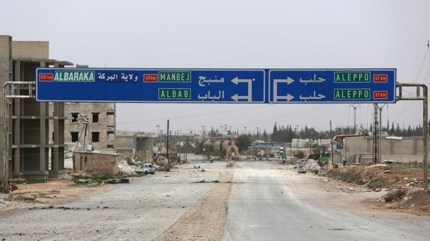 A road sign that shows the direction to Manbij city is seen in the northern Syrian town of al-Bab, Syria March 1, 2017. Picture taken March 1, 2017. REUTERS/Khalil Ashawi - RC15D78AB000