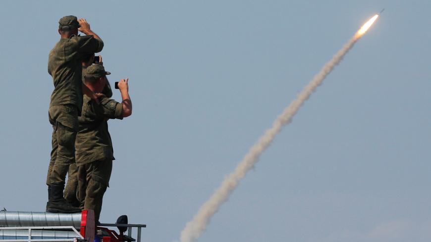 Russian servicemen watch the launch of the S-300 air defence system missile during the International Army Games 2016 at the Ashuluk military polygon outside Astrakhan, Russia, August 7, 2016. REUTERS/Maxim Shemetov - S1AETUBLCHAA