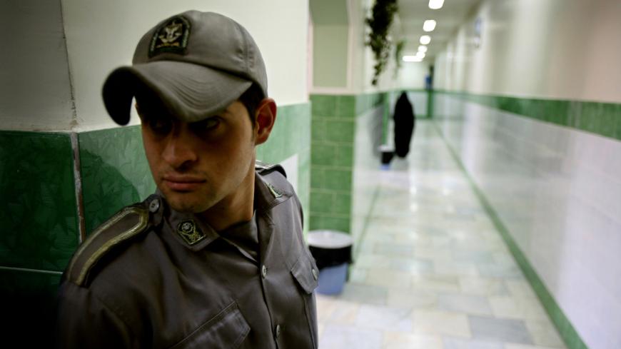 A prison guard stands along a corridor in Tehran's Evin prison June 13, 2006. Iranian police detained 70 people at a demonstration in favour of women's rights, the judiciary said on Tuesday, adding it was ready to review reports that the police had beaten some demonstrators. - PBEAHUNMBAM