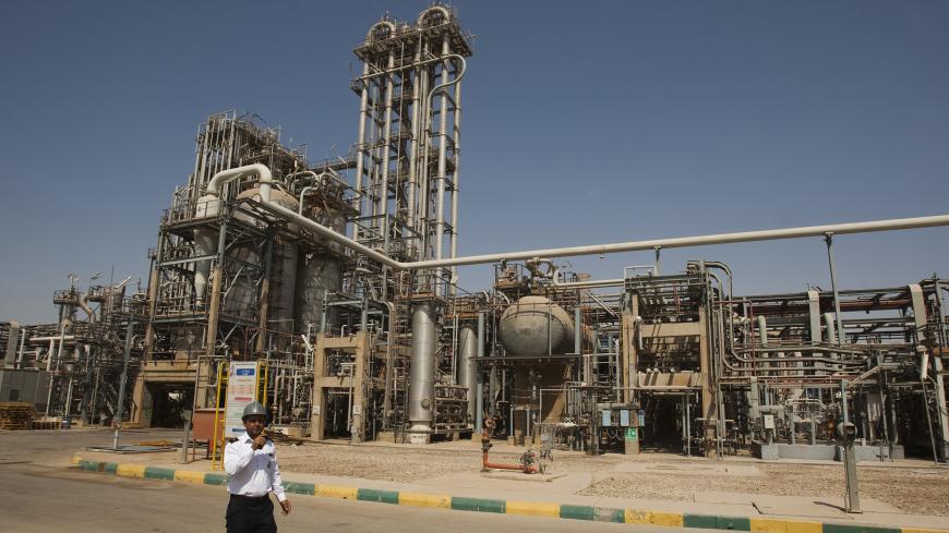 A security personnel stands in front of the Mahshahr petrochemical plant in Khuzestan province, 1032 km (641 miles) southwest of Tehran, September 28, 2011. REUTERS/Raheb Homavandi  (IRAN - Tags: BUSINESS ENERGY INDUSTRIAL) - GM1E79T0EIF01