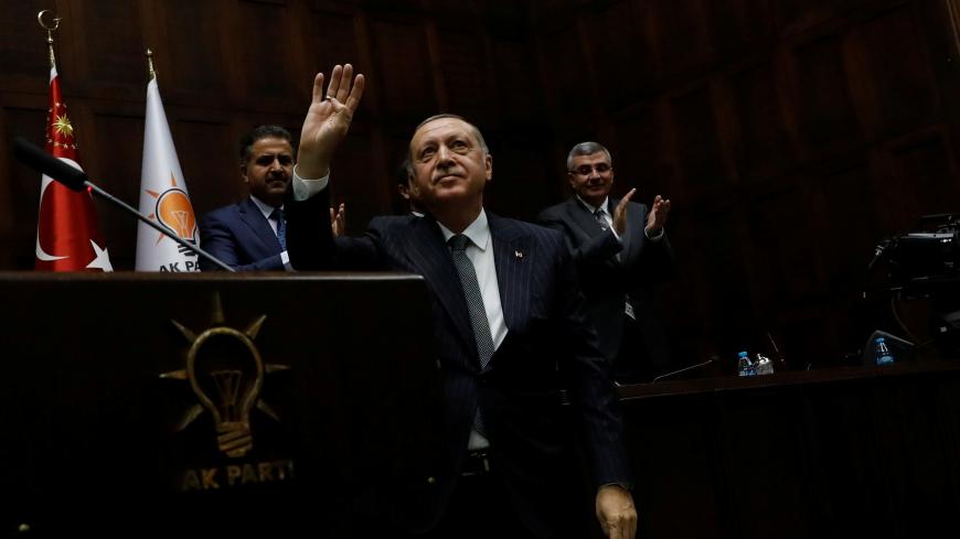 Turkish President Tayyip Erdogan greets members of parliament from his ruling AK Party (AKP) during a meeting at the Turkish parliament in Ankara, Turkey, October 2, 2018. REUTERS/Umit Bektas - RC19DE38A000