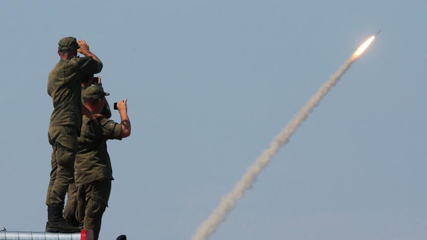 Russian servicemen watch the launch of the S-300 air defence system missile during the International Army Games 2016 at the Ashuluk military polygon outside Astrakhan, Russia, August 7, 2016. REUTERS/Maxim Shemetov - S1AETUBLCHAA