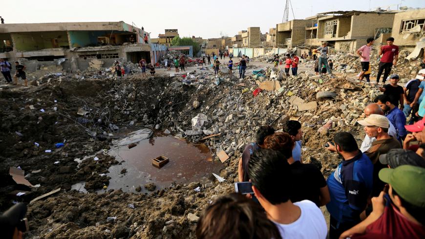 People gather at the site of an explosion in Baghdad's Sadr City district, Iraq June 7, 2018. REUTERS/Thaier Al-Sudani TPX IMAGES OF THE DAY - RC182A806690