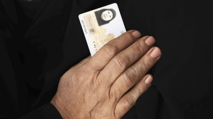 A woman with her ID arrives at a polling station to vote during the final stage of a referendum on Egypt's new constitution in Bani Sweif, about 115 km (71 miles) south of Cairo December 22, 2012. Queues formed at some polling stations around the country and voting was extended by four hours to 11 p.m. (2100 GMT). Last week's first round of voting, which an opposition leader said was marred by "serious violations", gave a 57 percent vote in favour of the constitution, according to unofficial figures. REUTER