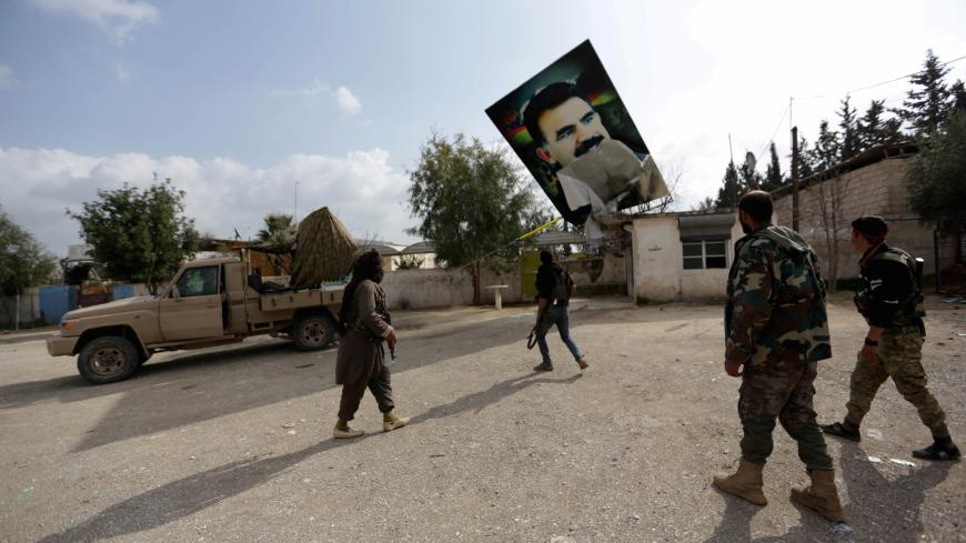 Turkish-backed Free Syrian Army fighters remove a picture of Kurdistan Workers Party (PKK) leader Abdullah Ocalan in Kafr Jana village north of Afrin, Syria March 7, 2018. REUTERS/Khalil Ashawi TPX IMAGES OF THE DAY - RC1E52C8D060