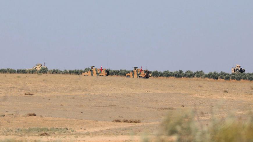 A Turkish flag flutters on a military vehicle on the border of Manbij city, Syria November 1, 2018. REUTERS/Rodi Said - RC1DD5250CE0