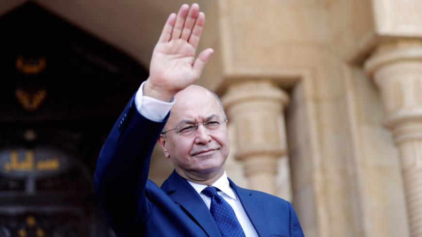 Barham Salih, Iraq's newly elected President greets Iraq's outgoing President Fuad Masum (not pictured) at the end of a handover ceremony at Salam Palace in Baghdad, Iraq October 3, 2018. REUTERS/Thaier Al-Sudani - RC1C2A8CDD30