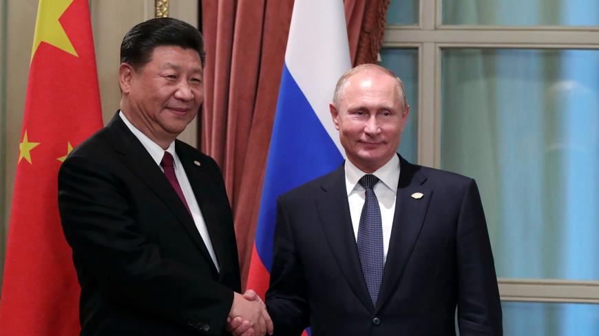 Russia's President Vladimir Putin (R) shakes hands with China's President Xi Jinping during a meeting on the sidelines of the G20 summit in Buenos Aires, Argentina November 30, 2018. Picture taken November 30, 2018. Sputnik/Mikhail Klimentyev/Kremlin via REUTERS  ATTENTION EDITORS - THIS IMAGE WAS PROVIDED BY A THIRD PARTY. - RC1AB6752940