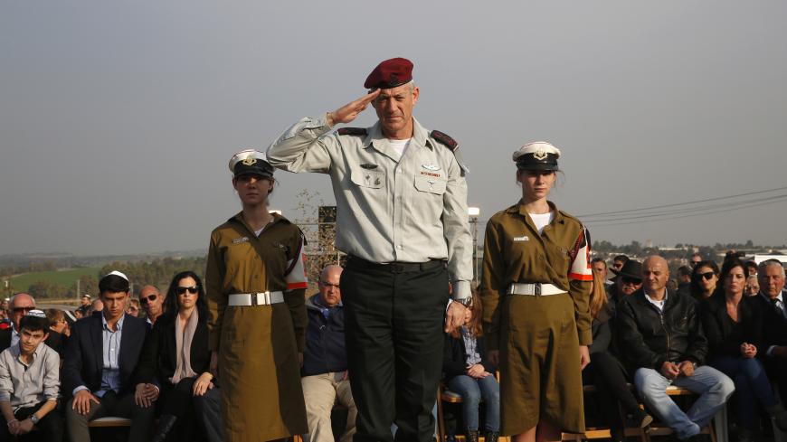 Israel's military chief Lieutenant-General Benny Gantz salutes in front of the grave of former Israeli Prime Minister Ariel Sharon during his funeral near Sycamore Farm, Sharon's residence in southern Israel, January 13, 2014. Israel buried Sharon at his family farm on Monday, celebrating the military achievements of a man seen as a war hero at home but as a war criminal by many in the Arab world. Sharon, 85, died on Saturday after spending the last eight years of his life motionless in a hospital bed, pitc