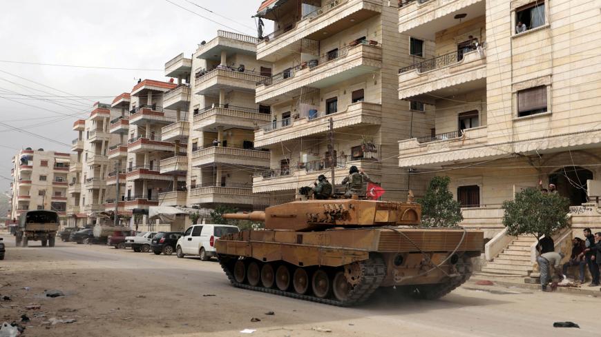 Turkish soldiers ride on a military vehicle in the center of Afrin, Syria March 24, 2018. REUTERS/Khalil Ashawi - RC1B6933DB00