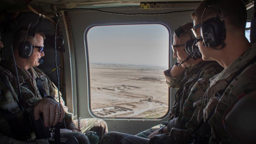 General Chiya, commander of the Syrian Democratic Forces in Syria’s Middle Euphrates River Valley, speaks with U.S. Army Lieutenant General Paul E. Funk, commander of Combined Joint Task Force-Operation Inherent Resolve and Major General James B. Jarrard, commander of Special Operations Joint Task Force-Operation Inherent Resolve, as they fly in a helicopter over Syria July 11, 2018. Picture taken July 11, 2018. U.S. Army/Sgt. Brigitte Morgan/Handout via REUTERS ATTENTION EDITORS - THIS IMAGES WAS PROVIDE