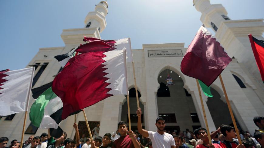 Palestinians take part in a rally in support of Qatar, inside Qatari-funded construction project 'Hamad City', in the southern Gaza Strip, June 9, 2017. REUTERS/Ibraheem Abu Mustafa - RC1AB3A40800