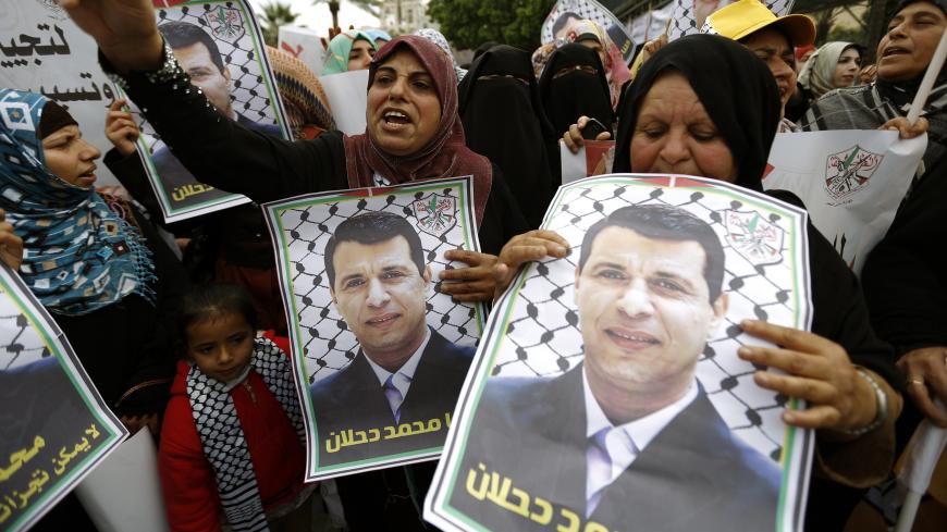 Palestinian supporters of dismissed senior Fatah leader Mohammed Dahlan shout slogans during a protest to support him on December 18, 2014 in Gaza City.  Thousands of supporters of exiled Palestinian strongman Mohammed Dahlan demonstrated in Gaza to protest the reported sacking of dozens of members of the security forces who back him. AFP PHOTO/ MOHAMMED ABED        (Photo credit should read MOHAMMED ABED/AFP/Getty Images)