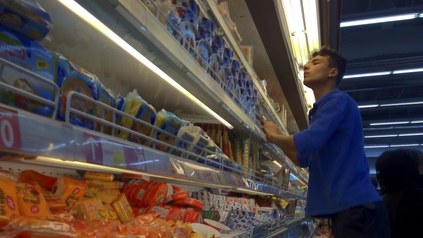 EDITORS' NOTE: Reuters and other foreign media are subject to Iranian restrictions on their ability to film or take pictures in Tehran.
An Iranian employee checks the food shelves at a shopping mall in northwestern Tehran February 3, 2012. With just a month to go before a parliamentary election, Iran has been hit hard in recent months by new U.S. and European economic sanctions over its nuclear programme, which Tehran says is peaceful but the West says is aimed at making a bomb. Picture taken February 3, 2