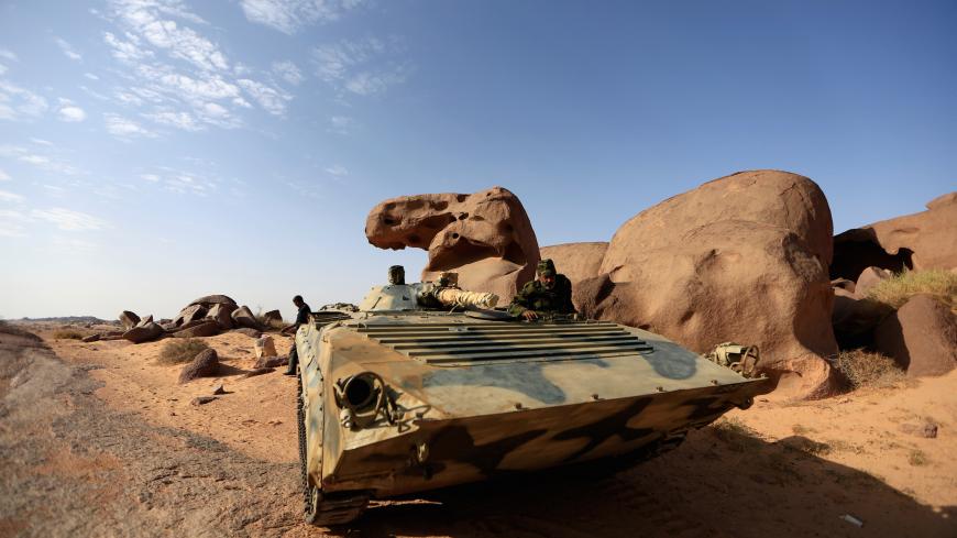 Hamuya Khalil, 49, a Polisario fighter, stands in an armored vehicle at a forward base on the outskirts of Tifariti, Western Sahara, September 9, 2016. REUTERS/ Zohra Bensemra SEARCH ìPOLISARIOî FOR THIS STORY. SEARCH "WIDER IMAGE" FOR ALL STORIES. - S1BEUKRIGMAA