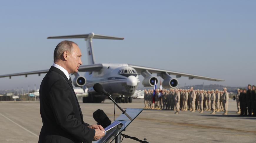 Russian President Vladimir Putin addresses servicemen as he visits the Hmeymim air base in Latakia Province, Syria December 11, 2017.  Sputnik/Mikhail Klimentyev/Sputnik via REUTERS  ATTENTION EDITORS - THIS IMAGE WAS PROVIDED BY A THIRD PARTY. - UP1EDCB10ZJ2B