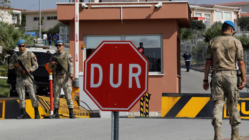 Soldiers stand guard at the entrance to the Aliaga Prison and Courthouse complex in Izmir, Turkey October 12, 2018. REUTERS/Umit Bektas - RC1B8D521D10