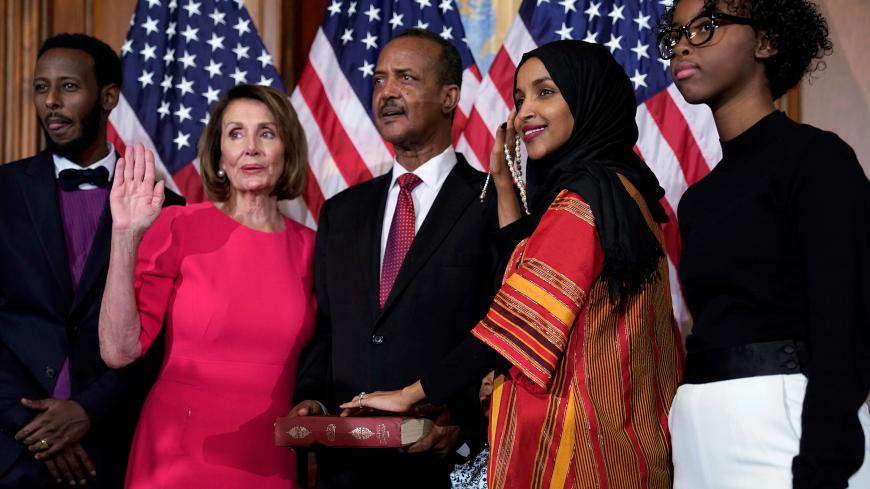 Rep. Ilhan Omar (D-MN) poses with Speaker of the House Nancy Pelosi (D-CA) for a ceremonial ceremonial swearing in picture on Capitol Hill in Washington, U.S., January 3, 2019. REUTERS/Joshua Roberts - RC1A408A84A0