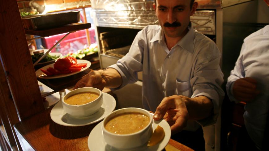 ISTANBUL, TURKEY - SEPTEMBER 28:  Balik Lokantasi restaurant's kitchen chief serves fish soup, in Karakoy district on September 28, 2006 in Istanbul, Turkey. Balik Lokantasi means Fish Restaurant in Turkish, as its name, it is a unequally fresh fish plates comes from the see or the Bosporus every day. its owner, Mr. Ozkaraman mentions that he doesn't have a refrigerator, when the fresh fish are finished he closes up the restaurant.  (Photo by Yoray Liberman/Getty Images)