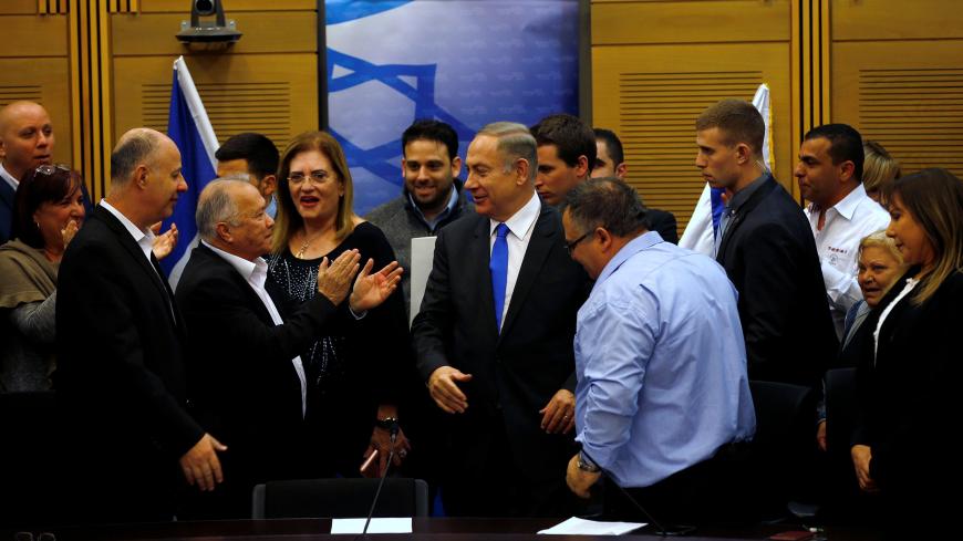 Israeli Prime Minister Benjamin Netanyahu (C) attends a Likud party meeting at the Knesset, the Israeli parliament, in Jerusalem January 16, 2017. Picture taken January 16, 2017. REUTERS/Ronen Zvulun - RC187DF66900