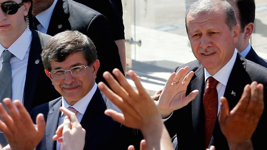 Turkey's then-Prime Minister Tayyip Erdogan (R) and then-Foreign Minister Ahmet Davutoglu greet their supporters as they leave Friday prayers in Ankara, Turkey, August 22, 2014. REUTERS/Umit Bektas/File Photo - D1AETCCKOAAA