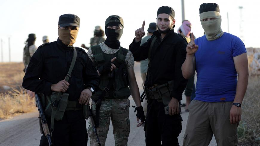 Islamist rebels from Hayat Tahrir al-Sham are seen outside the villages of al-Foua and Kefraya, Syria July 18, 2018. REUTERS/Khalil Ashawi - RC194E7A7120