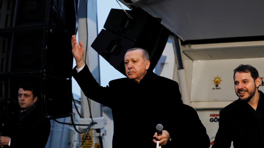Turkish President Tayyip Erdogan and Turkish Treasury and Finance Minister Berat Albayrak throw gifts during a rally for the upcoming local elections in Istanbul, Turkey, February 16, 2019. REUTERS/Umit Bektas - RC1AC12E5450