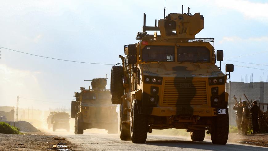 A column of armoured Turkish military vehicles drives along a road in the de-militarised zone in the northwestern Syrian town of Khan Sheikhun on March 17, 2019. - Khan Sheikhun is supposed to be protected by an internationally brokered ceasefire deal, but increased shelling and air strikes by regime forces last month have left its streets near empty. (Photo by - / AFP) (Photo credit should read -/AFP/Getty Images)