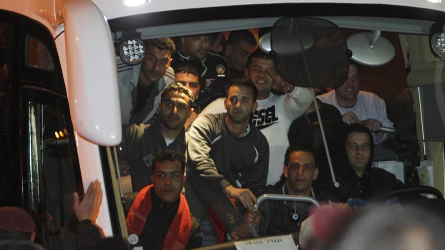 Newly released Palestinian prisoners wait to disembark from a bus upon their arrival to the West Bank city of Ramallah December 18, 2011. Israel released 550 Palestinian prisoners on Sunday in the second stage of a deal with Hamas that brought home soldier Gilad Shalit after five years of captivity in the Gaza Strip. REUTERS/Mohamad Torokman (WEST BANK - Tags: POLITICS) - GM1E7CJ0IXQ01