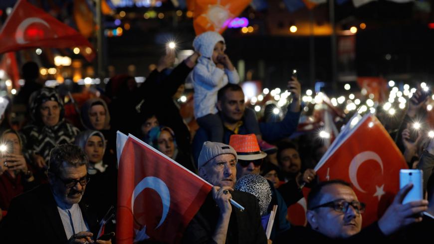 Supporters of Turkish President Tayyip Erdogan wave Turkish and party flags during a rally for the upcoming local elections in Istanbul, Turkey, March 19, 2019. REUTERS/Umit Bektas - RC1962789480