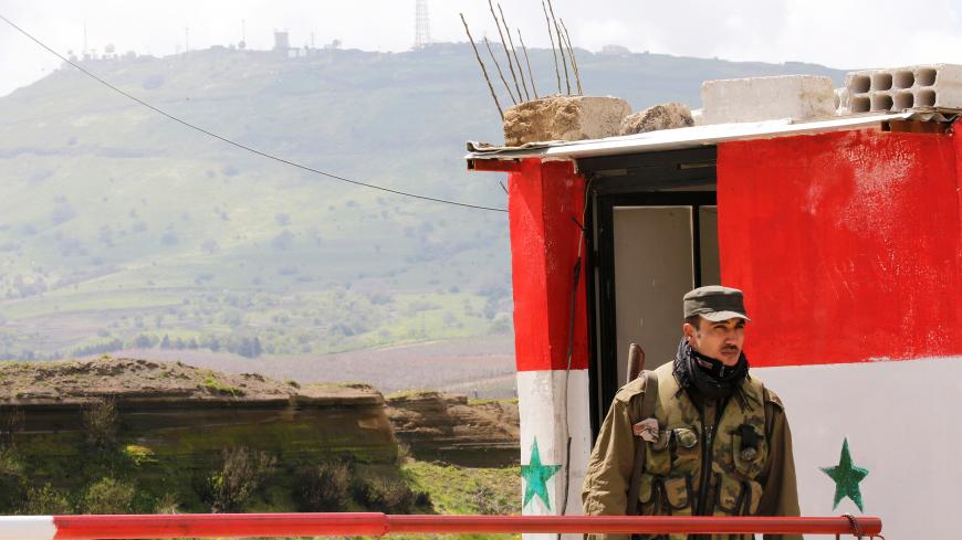 A Syrian army soldier stands at a checkpoint at the Quneitra crossing between the Israeli-controlled Golan Heights and Syria, seen from the Syrian side in Quneitra, Syria March 26, 2019. REUTERS/Omar Sanadiki - RC1B4F2B5A00