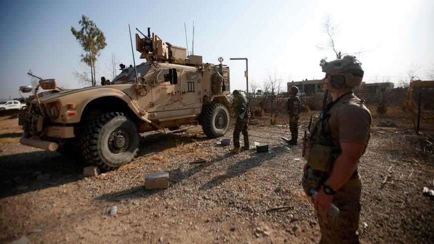 U.S. military vehicles are seen in the town of Bashiqa, east of Mosul, during an operation to attack Islamic State militants in Mosul, Iraq, November 7, 2016. REUTERS/Azad Lashkari - S1AEULMKDCAB