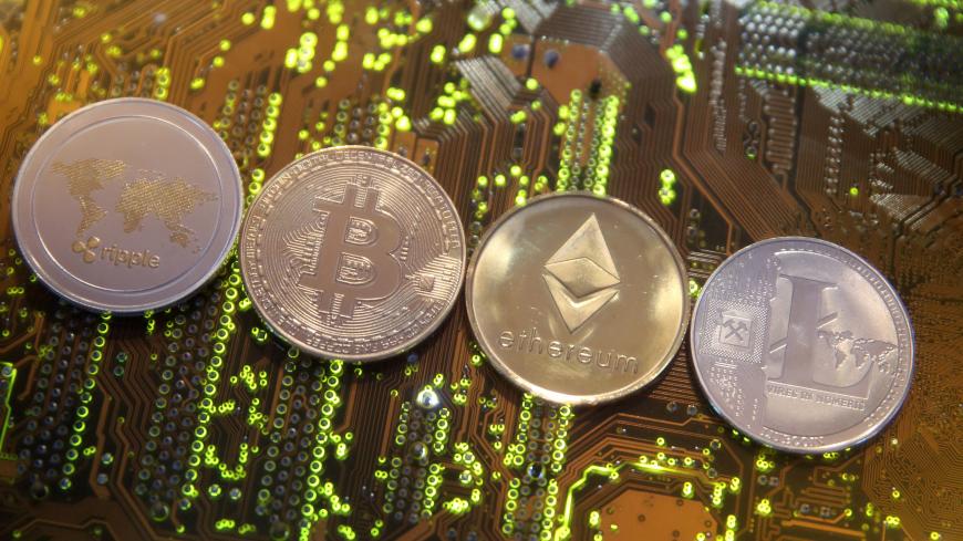 Representations of the Ripple, Bitcoin, Etherum and Litecoin virtual currencies are seen on a PC motherboard in this illustration picture, February 13, 2018. Picture is taken February 13, 2018. REUTERS/Dado Ruvic/Illustration - RC1993E31370