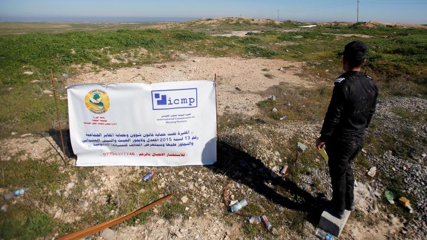 An Iraqi police officer looks at a Yazidi mass grave site near Sinjar, Iraq February 4, 2019. Picture taken February 4, 2019. REUTERS/Khalid al-Mousily - RC1AB34C8D60