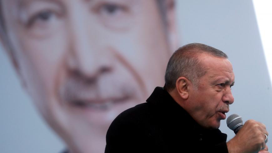 Turkish President Tayyip Erdogan addresses his supporters during a rally for the upcoming local elections, in Istanbul, Turkey March 12, 2019. REUTERS/Murad Sezer - RC18264B3470