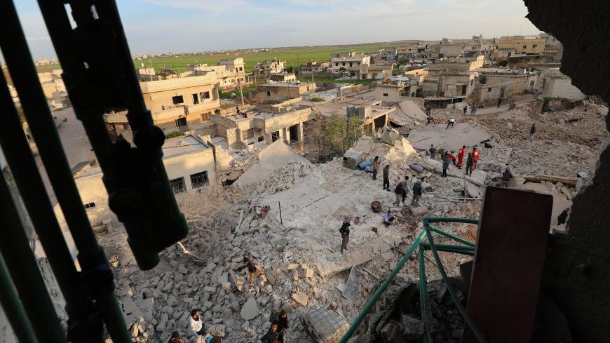 Members of the Syrian civil defence search for victims amidst destruction from reported air strikes in the town of Kafraya in the north of Idlib province on March 22, 2019. (Photo by OMAR HAJ KADOUR / AFP)        (Photo credit should read OMAR HAJ KADOUR/AFP/Getty Images)