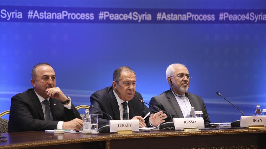 Foreign Ministers, Sergei Lavrov (C) of Russia, Mevlut Cavusoglu (L) of Turkey and Mohammad Javad Zarif of Iran, attend the international meeting on Syria in Astana, Kazakhstan March 16, 2018. REUTERS/Mukhtar Kholdorbekov - UP1EE3G0MJ01P
